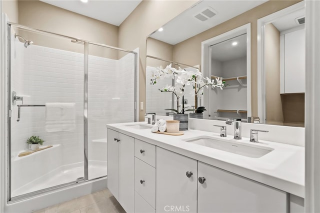 108 Coastal Gdn, Irvine, CA 92618 - bathroom featuring a stall shower, double vanity, tile patterned flooring, a walk in closet, and recessed lighting
