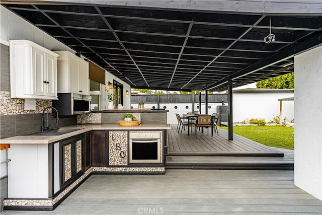 5893 E Adderley Dr, Long Beach, CA 90808 - wooden deck featuring area for grilling, outdoor dining space, and a bar