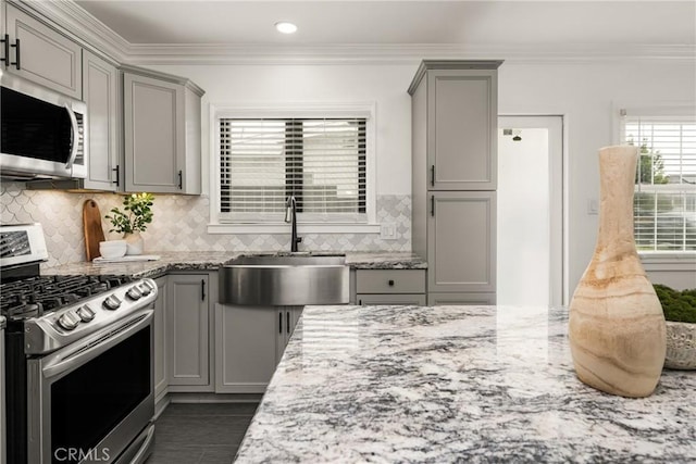 5893 E Adderley Dr, Long Beach, CA 90808 - kitchen with appliances with stainless steel finishes, gray cabinets, a sink, light stone countertops, and crown molding