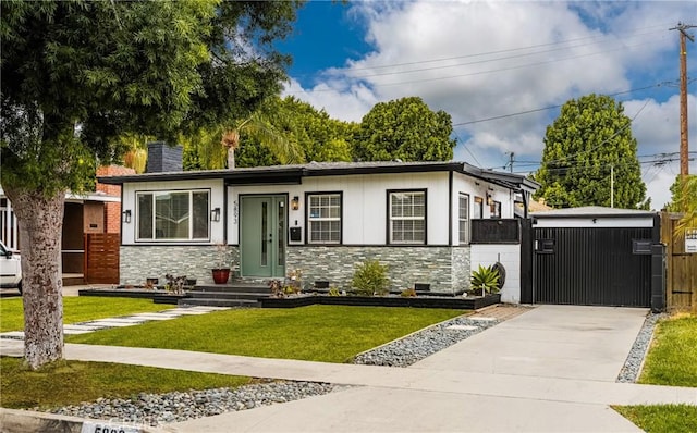 5893 E Adderley Dr, Long Beach, CA 90808 - view of front facade with stone siding, a front lawn, a chimney, and driveway