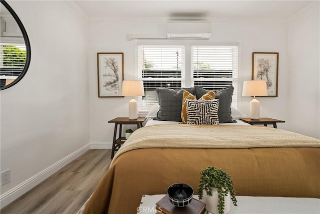 5893 E Adderley Dr, Long Beach, CA 90808 - bedroom with a wall mounted air conditioner, wood finished floors, crown molding, multiple windows, and baseboards