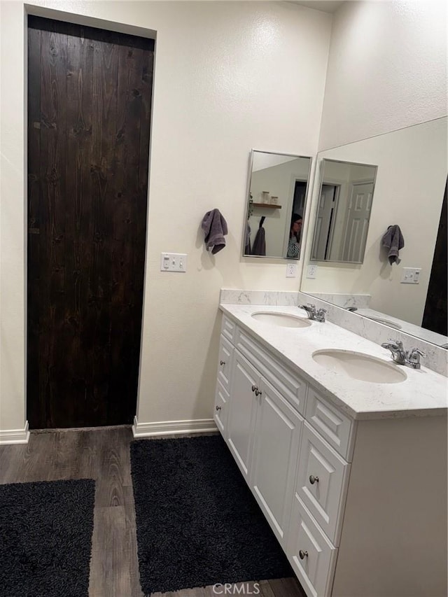 31827 Ives Ct, Menifee, CA 92584 - bathroom with wood finished floors, double vanity, and baseboards