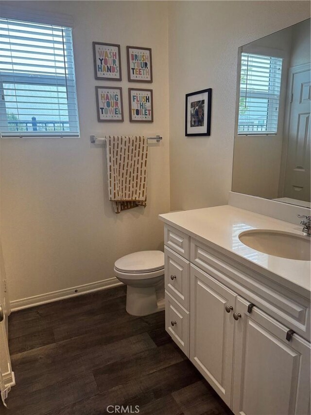 31827 Ives Ct, Menifee, CA 92584 - bathroom featuring wood finished floors, vanity, toilet, and plenty of natural light