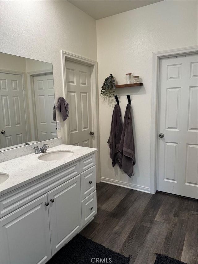 31827 Ives Ct, Menifee, CA 92584 - bathroom featuring double vanity, wood finished floors, and baseboards