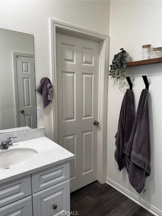 31827 Ives Ct, Menifee, CA 92584 - bathroom with vanity, wood finished floors, and baseboards