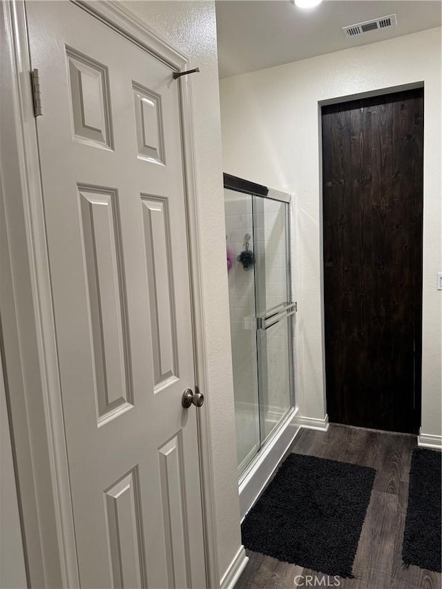 31827 Ives Ct, Menifee, CA 92584 - bathroom with wood finished floors, a shower stall, and baseboards