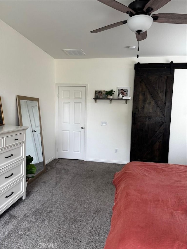 31827 Ives Ct, Menifee, CA 92584 - bedroom featuring dark carpet, a barn door, baseboards, and a ceiling fan