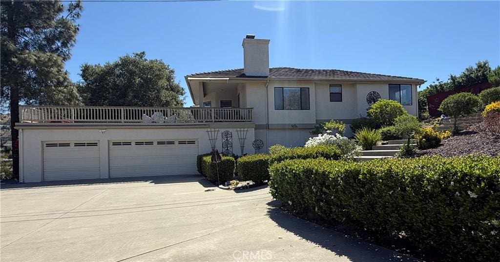 1357 Sunny Heights Rd, Fallbrook, CA 92028 - view of front facade with a chimney, driveway, stucco siding, a balcony, and an attached garage