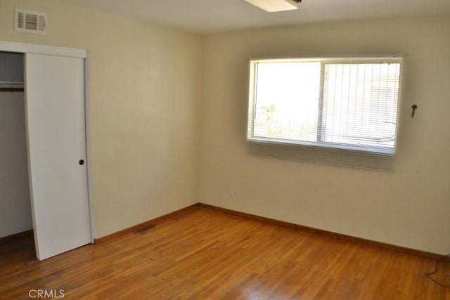 10111 Dewey Dr, Garden Grove, CA 92840 - unfurnished bedroom featuring light wood finished floors, a closet, and baseboards