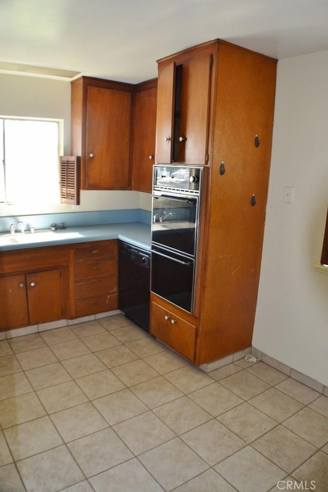10111 Dewey Dr, Garden Grove, CA 92840 - kitchen with double wall oven, dishwasher, light countertops, and brown cabinetry