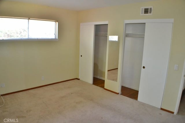 10111 Dewey Dr, Garden Grove, CA 92840 - unfurnished bedroom featuring two closets, carpet, and baseboards