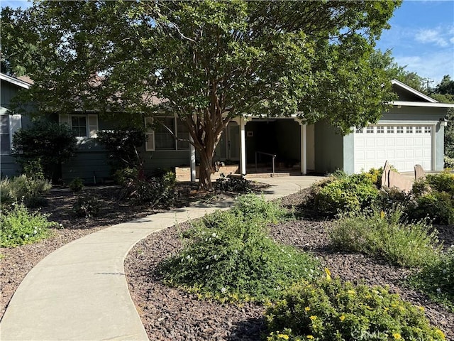 117 S Park Dr, Madera, CA 93637 - view of property hidden behind natural elements with an attached garage