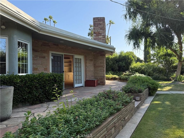 117 S Park Dr, Madera, CA 93637 - doorway to property with a chimney and stone siding