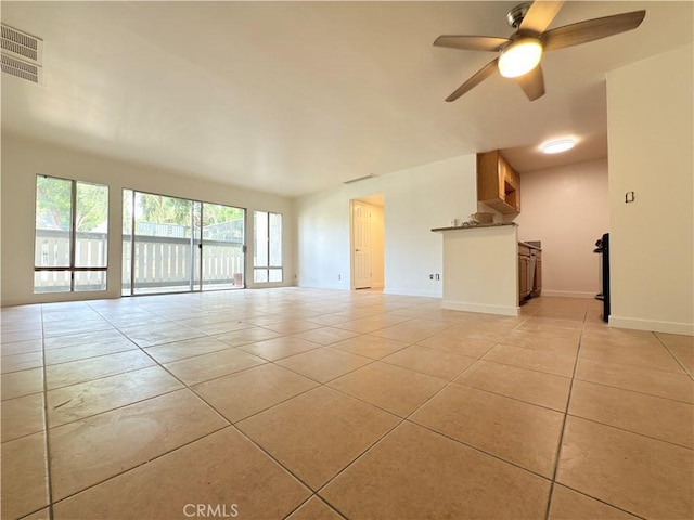8601 International Ave Unit 179, Canoga Park, CA 91304 - unfurnished living room featuring light tile patterned floors, a ceiling fan, and baseboards