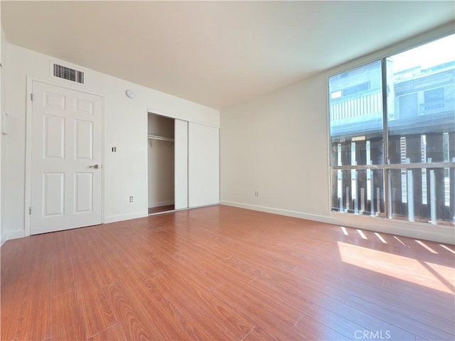 8601 International Ave Unit 179, Canoga Park, CA 91304 - unfurnished bedroom featuring wood finished floors, a closet, and baseboards