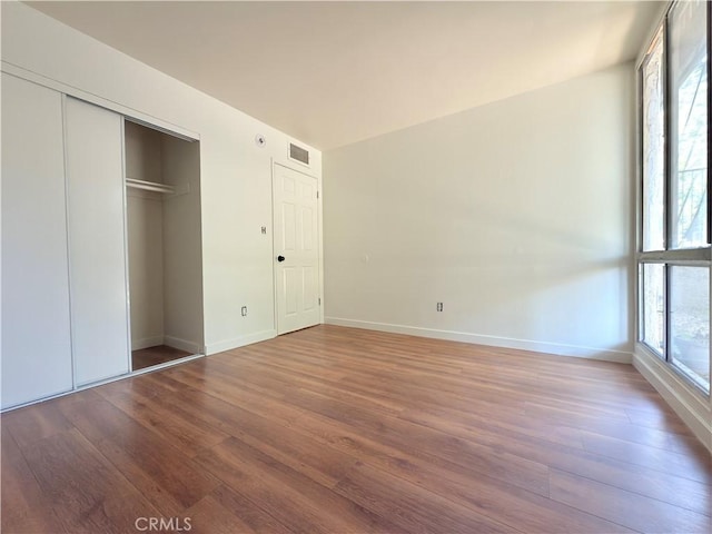 8601 International Ave Unit 179, Canoga Park, CA 91304 - unfurnished bedroom with wood finished floors, baseboards, and a closet