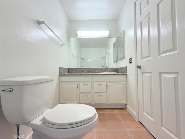 8601 International Ave Unit 179, Canoga Park, CA 91304 - bathroom with toilet, vanity, tile patterned flooring, and a shower