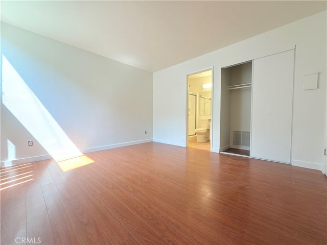8601 International Ave Unit 179, Canoga Park, CA 91304 - unfurnished bedroom featuring wood finished floors, a closet, baseboards, and ensuite bath