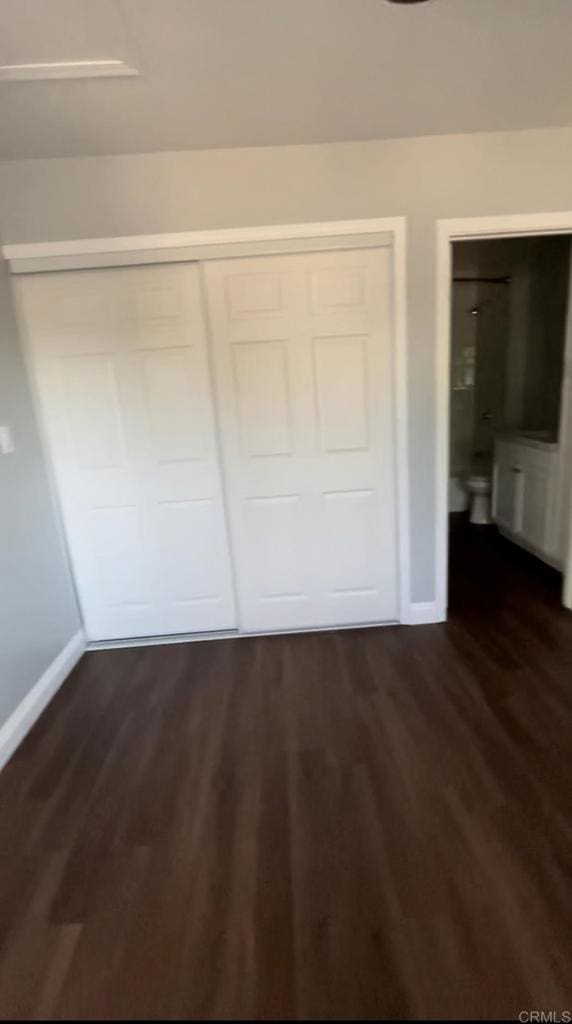 141921 Flo Dr, Alpine, CA 91901 - unfurnished bedroom featuring baseboards, dark wood-style floors, and a closet