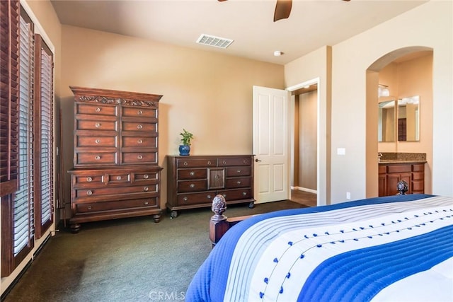 36235 Bay Hill Dr, Beaumont, CA 92223 - carpeted bedroom with arched walkways, baseboards, ensuite bath, and a ceiling fan