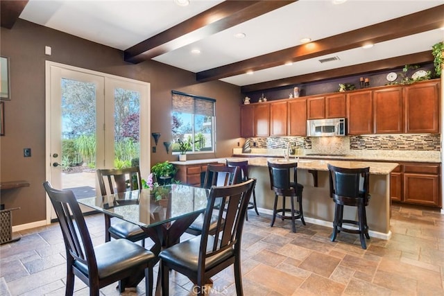 36235 Bay Hill Dr, Beaumont, CA 92223 - dining area featuring beamed ceiling, stone tile flooring, baseboards, and recessed lighting