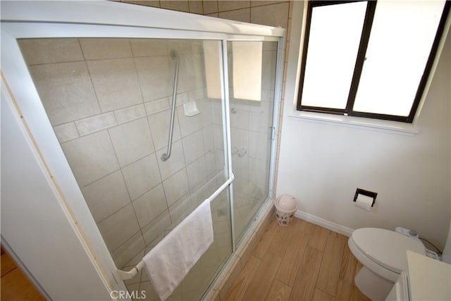 14279 Galleon Ln, Helendale, CA 92342 - bathroom featuring toilet, wood finished floors, a shower stall, and baseboards