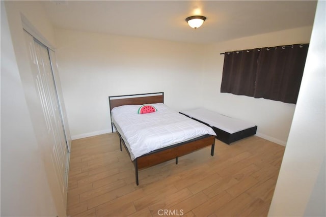 14279 Galleon Ln, Helendale, CA 92342 - bedroom with light wood-type flooring, baseboards, and a closet