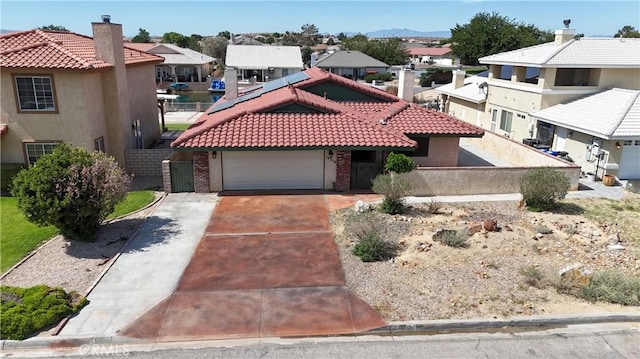 14279 Galleon Ln, Helendale, CA 92342 - view of front of property with a residential view, a tiled roof, brick siding, and an attached garage