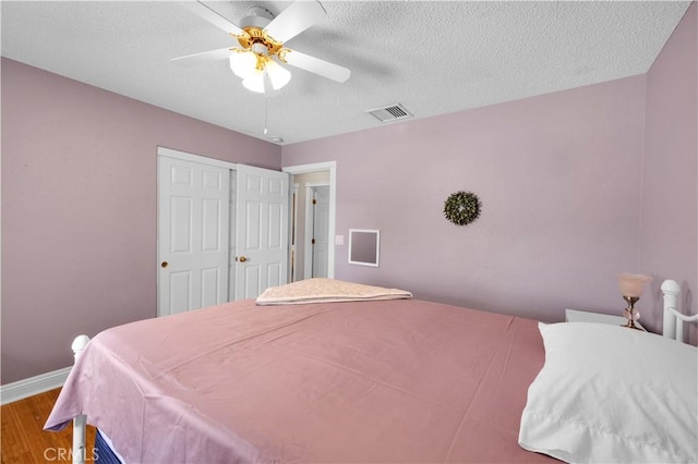 6279 Baileya Ave Unit 29, Palms, CA 92277 - bedroom with wood finished floors, baseboards, a textured ceiling, and ceiling fan