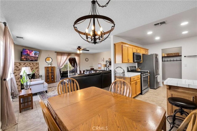 6279 Baileya Ave Unit 29, Palms, CA 92277 - dining room featuring a chandelier, light tile patterned flooring, ceiling fan, a textured ceiling, and recessed lighting