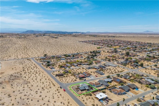 6279 Baileya Ave Unit 29, Palms, CA 92277 - aerial perspective of suburban area with a mountainous background, a desert landscape, and property parcel outlined