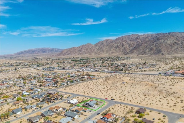 6279 Baileya Ave Unit 29, Palms, CA 92277 - aerial view of residential area featuring a mountain backdrop, a desert landscape, and property boundaries highlighted