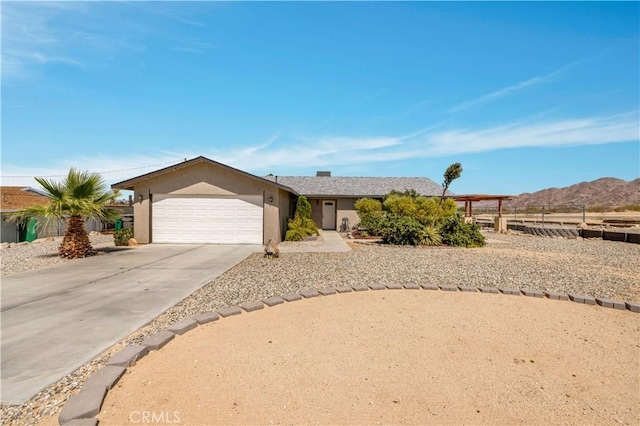 6279 Baileya Ave Unit 29, Palms, CA 92277 - ranch-style home featuring driveway, an attached garage, stucco siding, and a mountain view