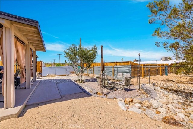 6279 Baileya Ave Unit 29, Palms, CA 92277 - fenced backyard with a patio area