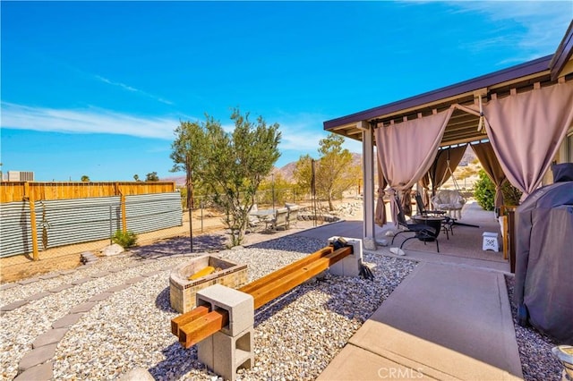 6279 Baileya Ave Unit 29, Palms, CA 92277 - fenced backyard featuring a patio and a fire pit