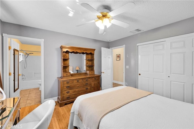 6279 Baileya Ave Unit 29, Palms, CA 92277 - bedroom with a closet, light wood-type flooring, a ceiling fan, baseboards, and connected bathroom