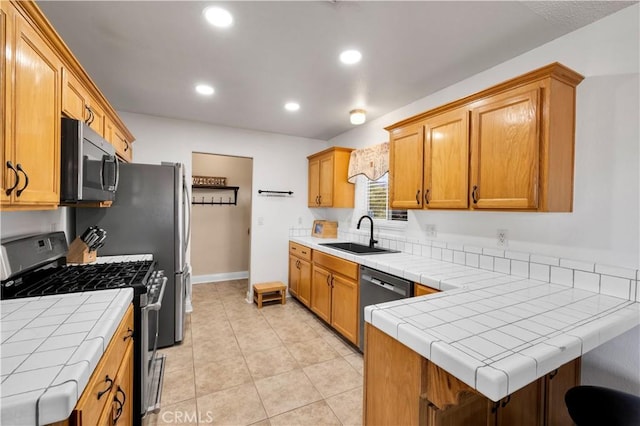 6279 Baileya Ave Unit 29, Palms, CA 92277 - kitchen with appliances with stainless steel finishes, a sink, tile counters, recessed lighting, and a peninsula