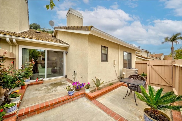 2201 Dublin Ln Unit 3, Diamond Bar, CA 91765 - back of house featuring central AC, a patio, a gate, stucco siding, and a chimney