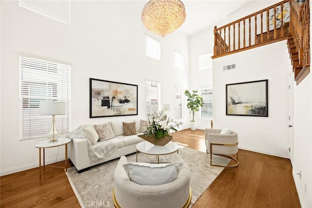 4937 Peck Rd Unit C, El Monte, CA 91732 - living room with wood finished floors, baseboards, a high ceiling, and a chandelier