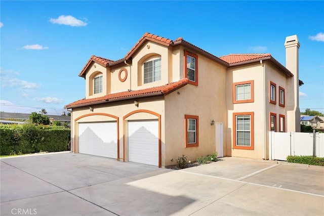 4937 Peck Rd Unit C, El Monte, CA 91732 - mediterranean / spanish-style house featuring a garage, driveway, stucco siding, and a tiled roof