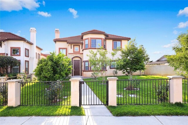 4937 Peck Rd Unit C, El Monte, CA 91732 - mediterranean / spanish-style home with a fenced front yard, stucco siding, a chimney, a tile roof, and a gate
