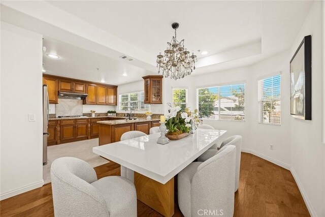 4937 Peck Rd Unit C, El Monte, CA 91732 - dining room featuring a chandelier, recessed lighting, wood finished floors, and a raised ceiling