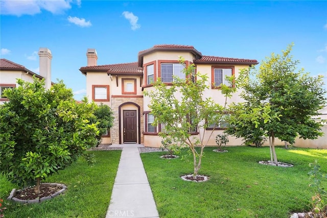 4937 Peck Rd Unit C, El Monte, CA 91732 - mediterranean / spanish house featuring stucco siding, a chimney, a front lawn, and a tiled roof