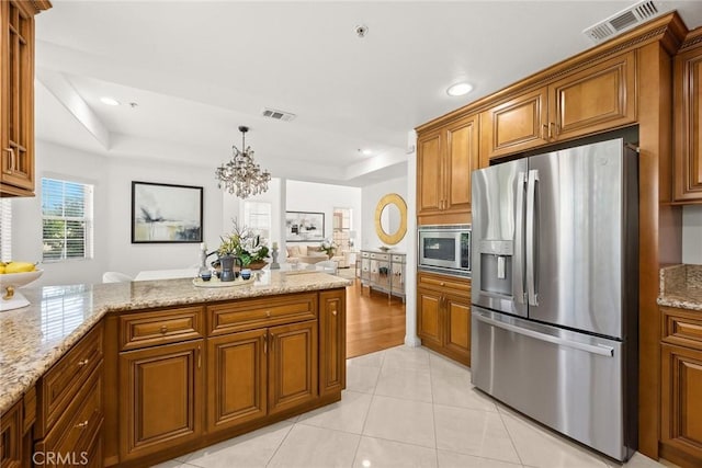 4937 Peck Rd Unit C, El Monte, CA 91732 - kitchen with appliances with stainless steel finishes, brown cabinetry, a peninsula, a raised ceiling, and recessed lighting