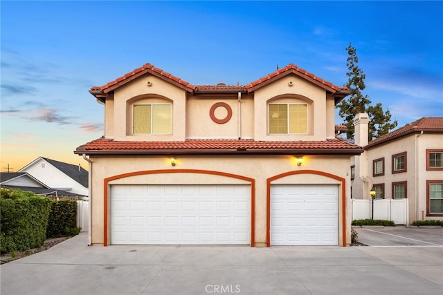 4937 Peck Rd Unit C, El Monte, CA 91732 - mediterranean / spanish-style house with stucco siding, an attached garage, a tile roof, and concrete driveway