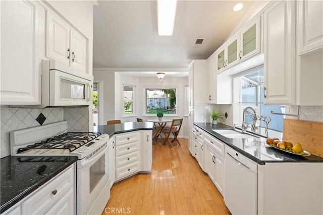 3014 California Park Dr, Chico, CA 95928 - kitchen featuring white appliances, white cabinets, light wood-style floors, a sink, and decorative backsplash