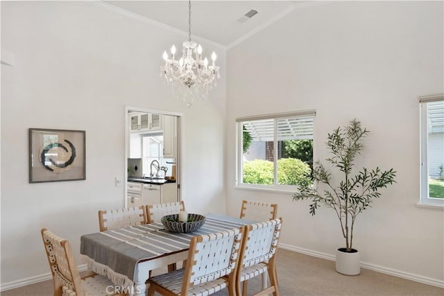 3014 California Park Dr, Chico, CA 95928 - dining space featuring high vaulted ceiling, light carpet, a chandelier, ornamental molding, and plenty of natural light