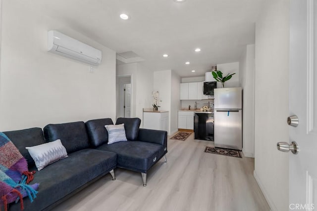 7701 Baird Ave, Reseda, CA 91335 - living area with a wall mounted air conditioner, light wood finished floors, recessed lighting, and baseboards