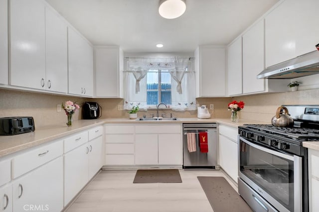 7701 Baird Ave, Reseda, CA 91335 - kitchen with stainless steel appliances, a sink, white cabinets, light countertops, and recessed lighting