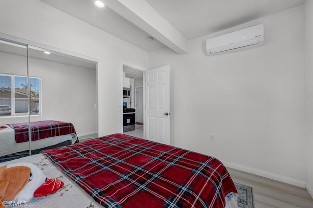 7701 Baird Ave, Reseda, CA 91335 - bedroom featuring a wall mounted AC, baseboards, recessed lighting, wood finished floors, and a closet